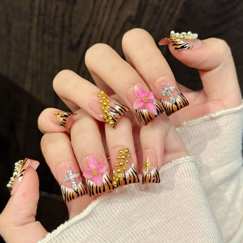 Premium duck nails for fierce glamour - black tiger stripes, 3D pink flower, crystal cross, luxurious gold crown, pearl & star accents, perfect for bold celebrations