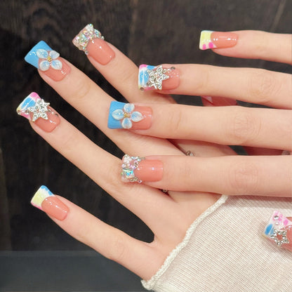Premium duck nails for kawaii dreams - sparkling stars, delicate blue flower, rainbow gradient, holographic glitter, perfect for unicorn celebrations