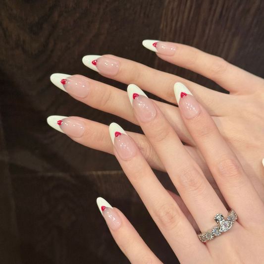 Premium handmade almond press-on nails with classic French tips & adorable red heart accents for romantic elegance