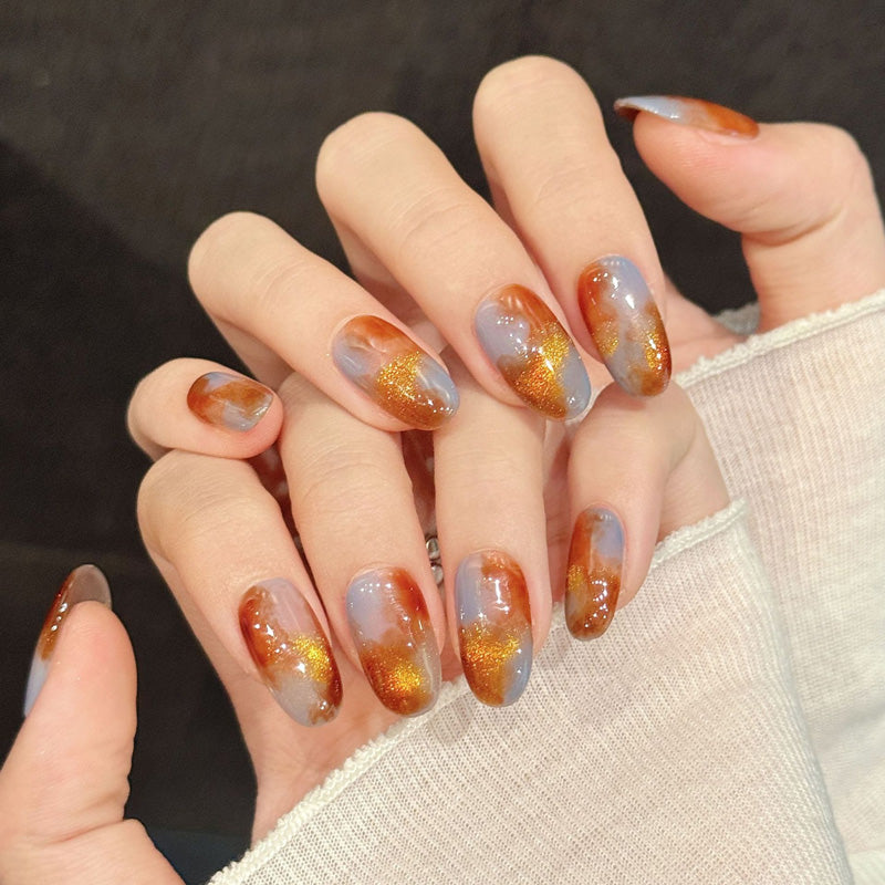 Premium oval nails for elegant charm - sophisticated tortoiseshell, sparkling gold accents, warm amber gradient, perfect for autumn celebrations