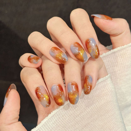 Premium oval nails for elegant charm - sophisticated tortoiseshell, sparkling gold accents, warm amber gradient, perfect for autumn celebrations