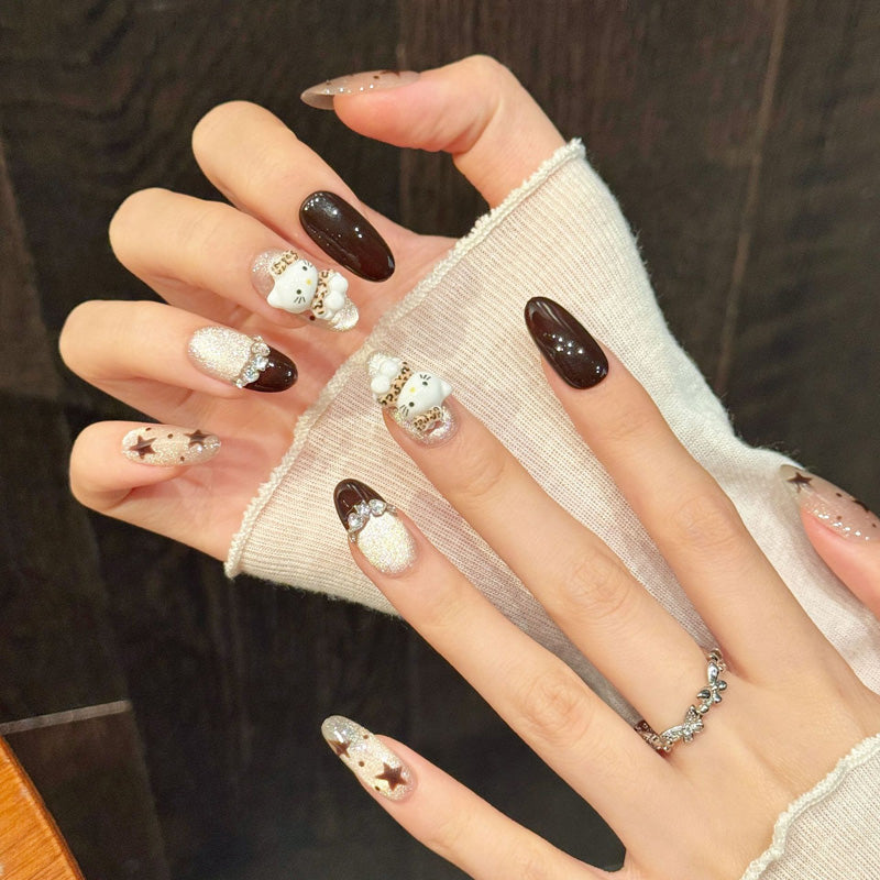 Premium oval nails for kawaii charm - Hello Kitty with leopard bow, brown stars, silver glitter, deep black, crystal accents, perfect for playful celebrations