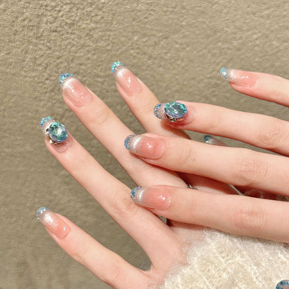 Premium oval nails for ocean elegance - large blue crystal, silver-blue glitter French tips, peach gradient, iridescent shells, perfect for beach celebrations