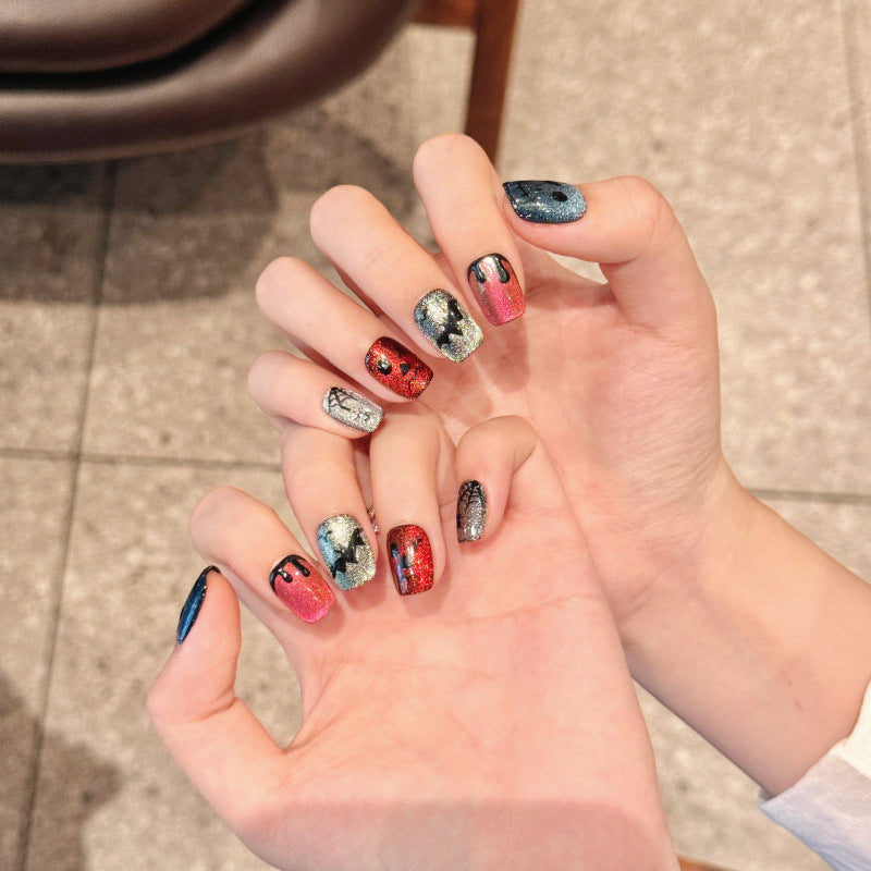 Premium quality Halloween press-on nails featuring multi-colored glitter skulls, squoval short design, easy DIY application