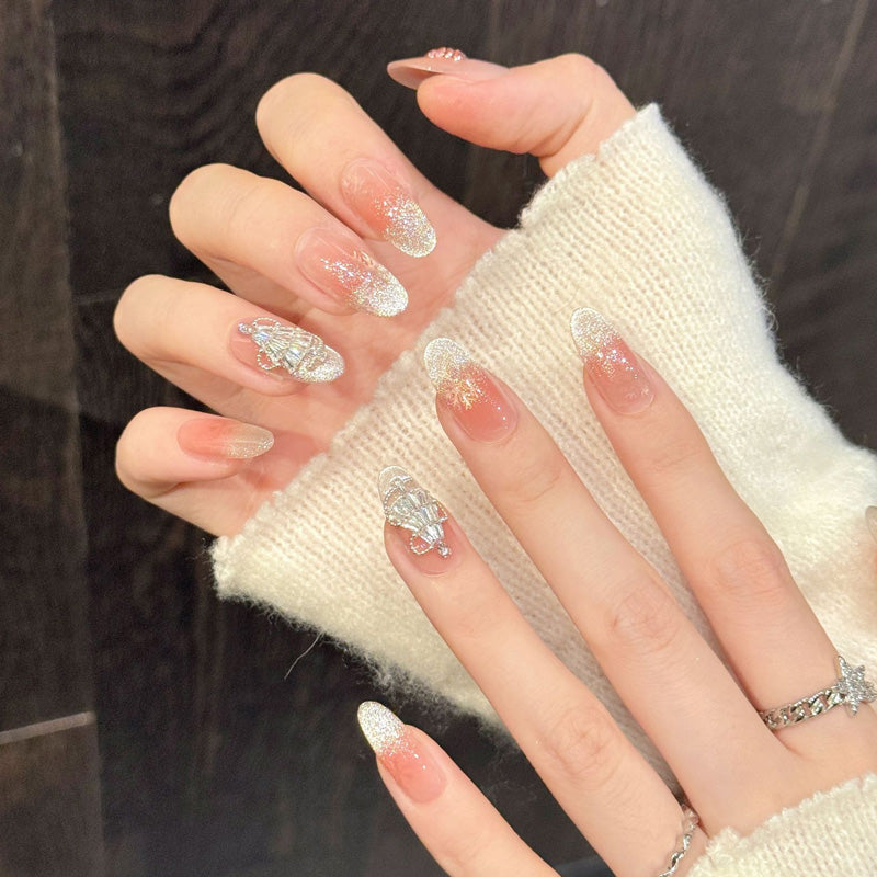 Romantic Christmas oval nails with warm gradient, silver snow effect & rhinestone-topped trees - refined festive nail collection