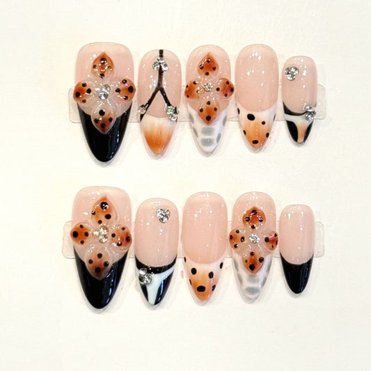 Romantic Paris-inspired almond press-ons with Eiffel Tower art, leopard hearts & French tips - handcrafted wanderlust nail design