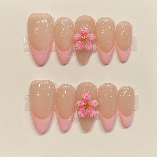 Romantic almond press-ons with seamless nude-to-pink gradient & sculptural 3D flower - handcrafted translucent jelly nail art