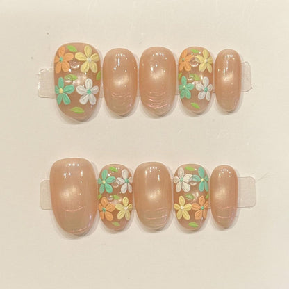 Romantic oval nails with 3D floral design, nude base, pastel spring flowers & gold beads - perfect for nude floral garden pastel spring romantic charm