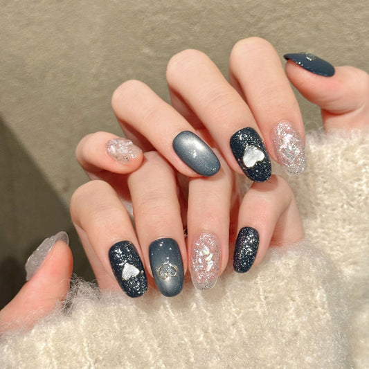 Romantic oval nails with silver hearts, galaxy glitter, grey-blue gradient & shimmer - perfect for silver heart galaxy elegance & celestial style