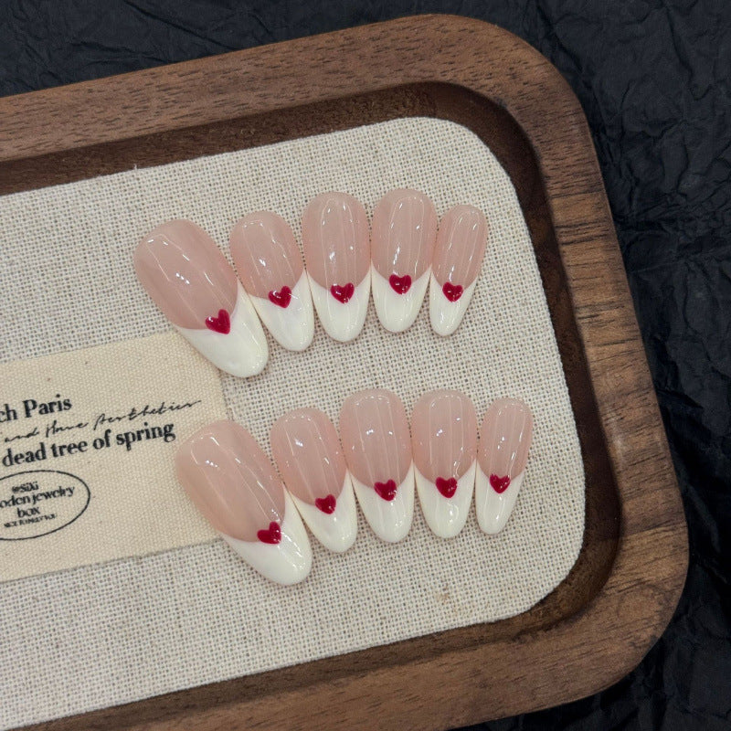 Salon-quality almond press-on nails with French heart design - timeless elegance meets playful romance in every nail