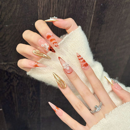 Show-stopping long pointed nails in warm tones with sparkling crosses, chrome finish & romantic florals - fierce fashion nail art