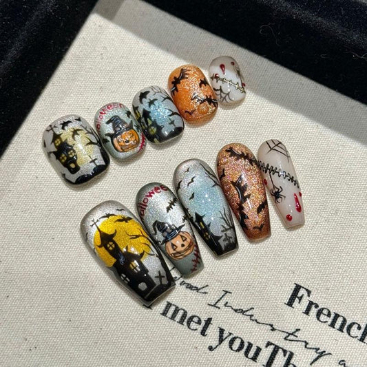Spooky Halloween cemetery press-on nails with mixed oval short and coffin medium shapes, featuring haunting graveyard scenes