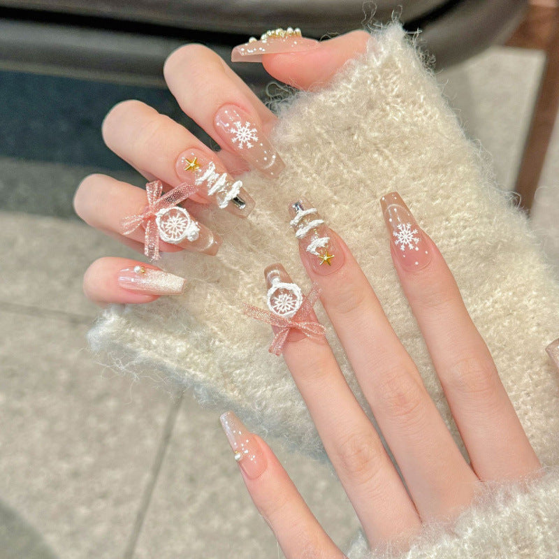 Stunning coffin medium press-on nails with snowflakes, ribbon bows, crystals & gold stars - perfect for winter wonderland glam & holiday celebrations