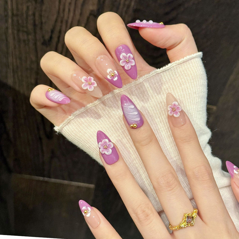Sunset-inspired purple almond nails with smooth gradient, dimensional florals & wave details - feminine handcrafted nail art
