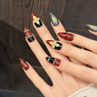 Vintage-inspired tortoiseshell almond nails with dimensional gold stars, rhinestone constellations & chains - gothic elegance