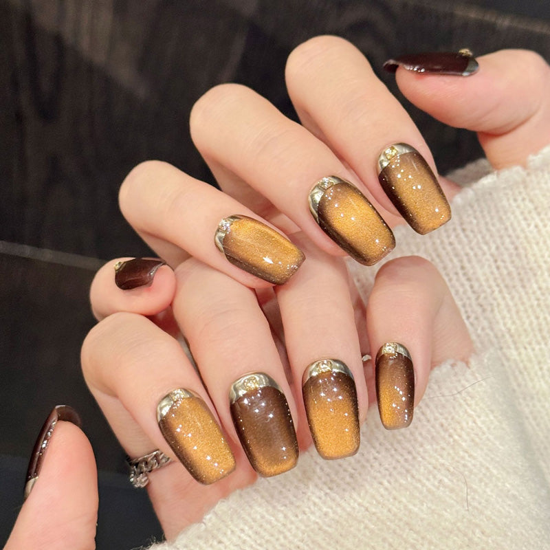 Warm caramel coffin false nails featuring unique granulated finish, bronze ombré & metallic gold tips - sophisticated 10-piece set