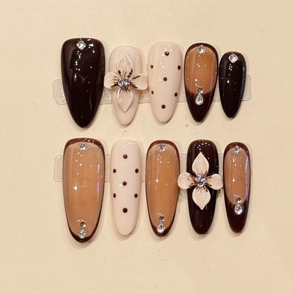 Warm chocolate & nude almond press-ons with 3D sculpted white florals, crystal centers & polka dots - handcrafted luxury nail art