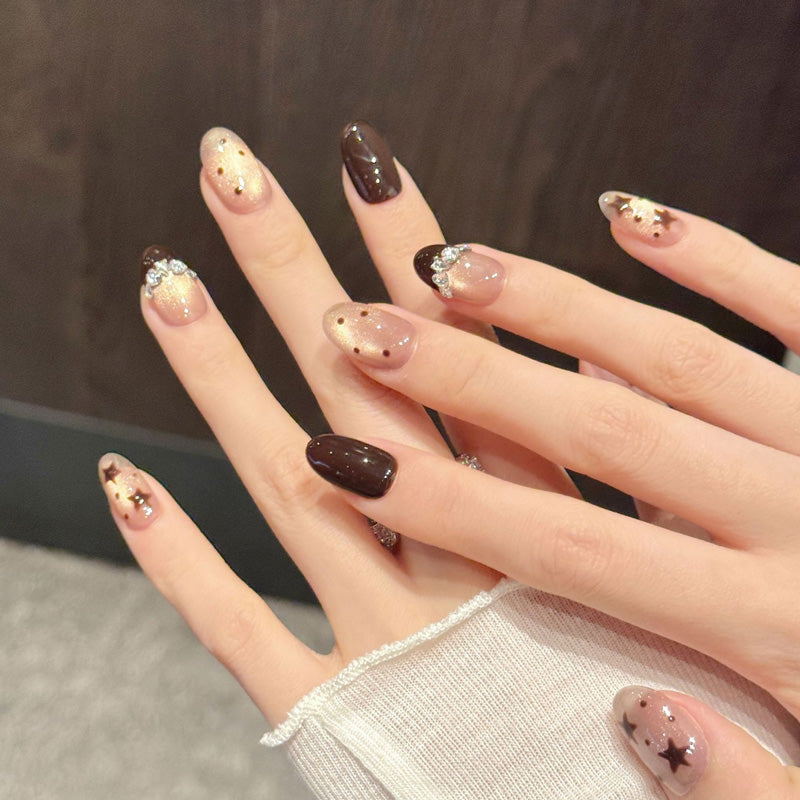 Whimsical chocolate & champagne oval false nails featuring dimensional stars, rhinestone bow & twilight dots - dreamy 10-piece set